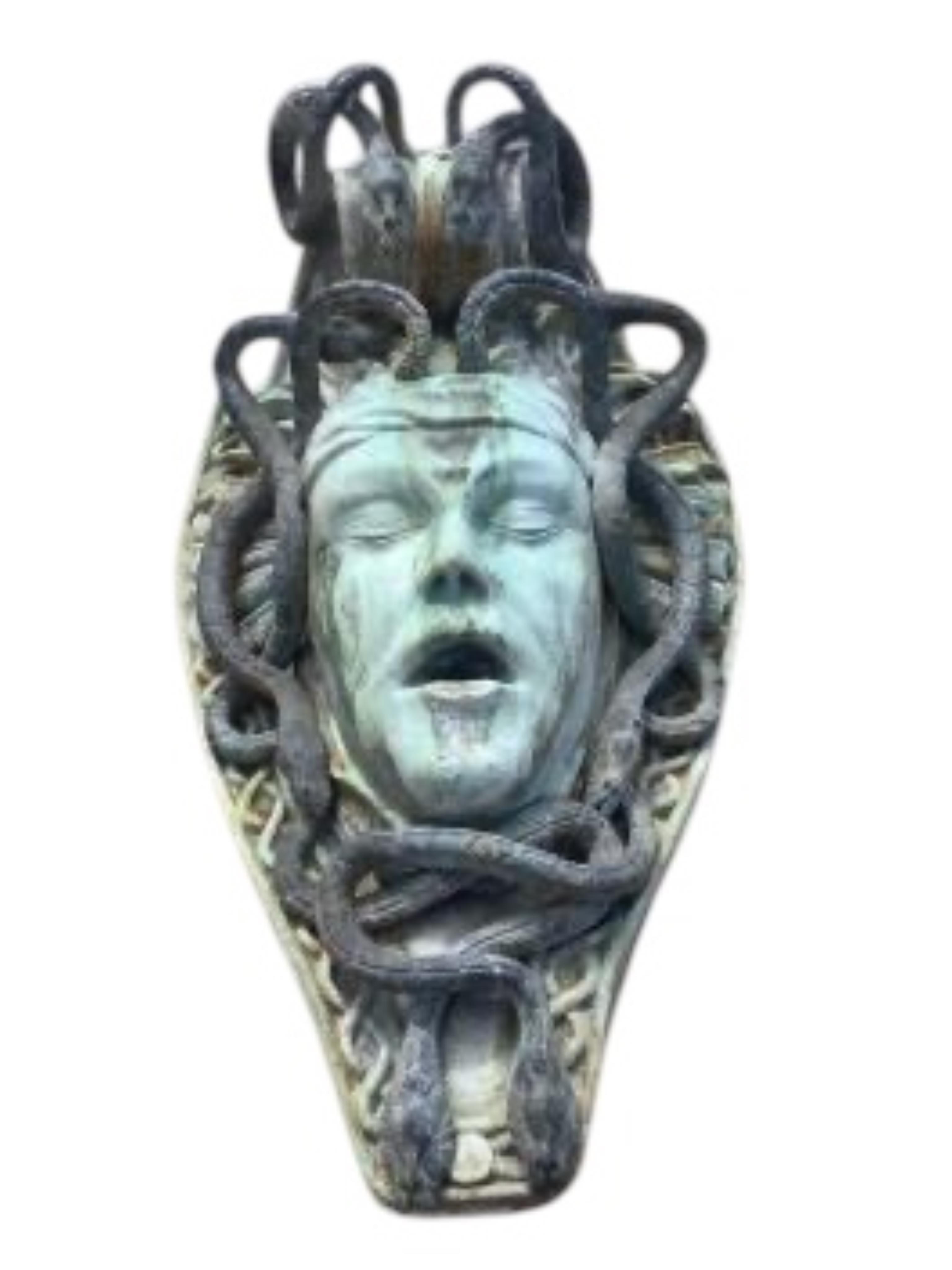 A reconstituted marble and lead Medusa wall fountain head, height 54cm